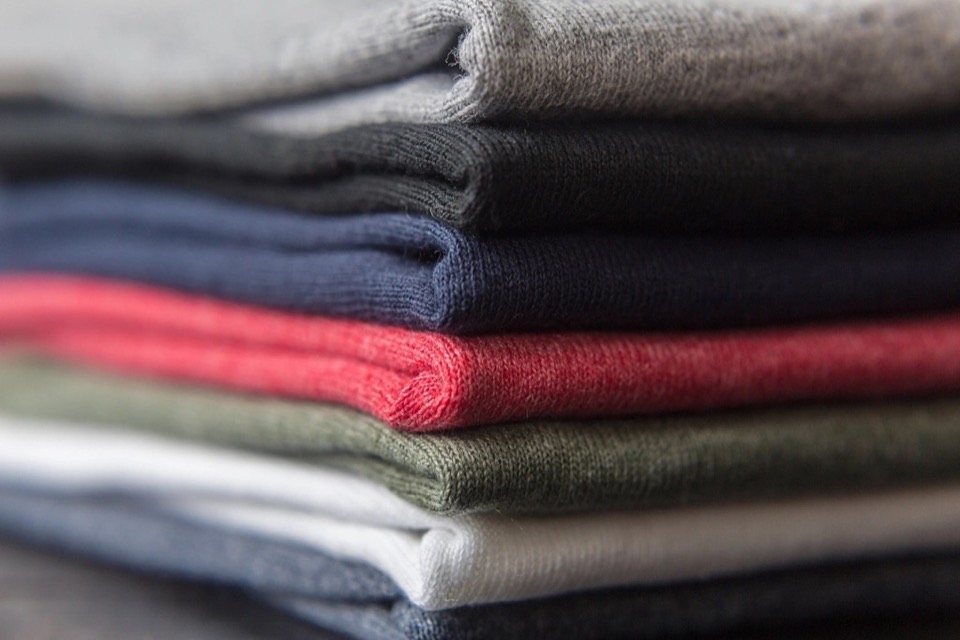 A neat stack of freshly folded t-shirts